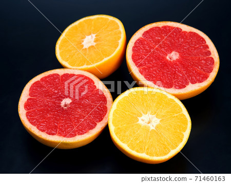 cut pieces of different citrus fruits on dark background cut pieces of different citrus fruits on dark background 71460163