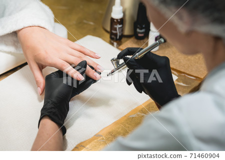 Closeup shot of a woman in a nail salon receiving 71460904