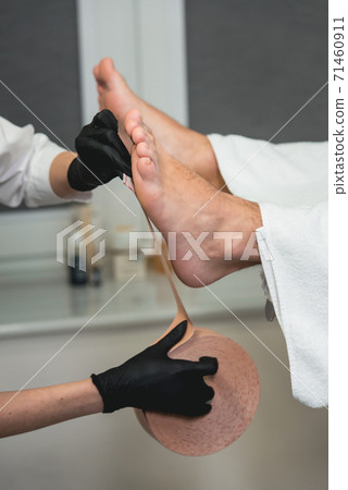 Therapeutic treatment of leg with beige physio Therapeutic treatment of leg with beige physio 71460911