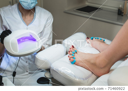 Pedicure foot and nails treatment with cosmetic Pedicure foot and nails treatment with cosmetic 71460922