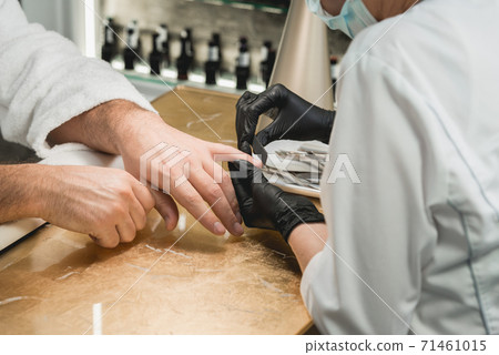 mans manicure master during nail treatment mans manicure master during nail treatment 71461015