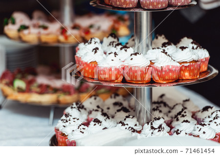 Pink craemy cakes on a stand. Close Up Pink craemy cakes on a stand. Close Up 71461454