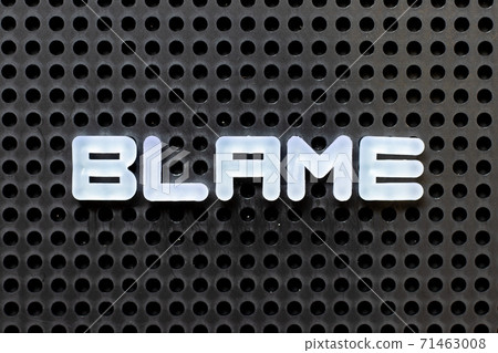 White color alphabet with word blame on black pegboard background White color alphabet with word blame on black pegboard background 71463008