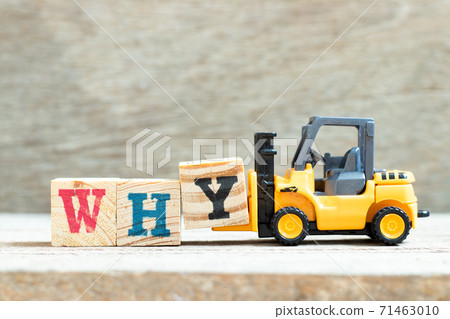 Toy forklift hold letter block y to complete word why on wood background 71463010
