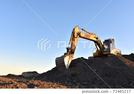 Excavator working on earthmoving at open pit mining. Excavator working on earthmoving at open pit mining. 71465217