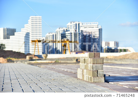 Process of installing paving bricks at construction site. Laying paving slabs Process of installing paving bricks at construction site. Laying paving slabs 71465248