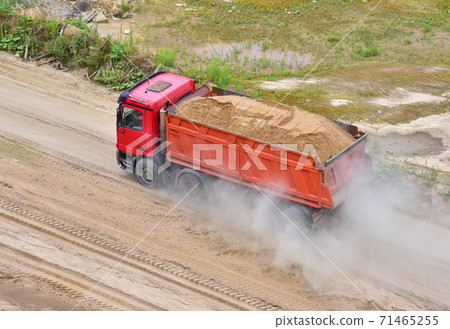 Dump truck transports sand in open pit mine.  71465255
