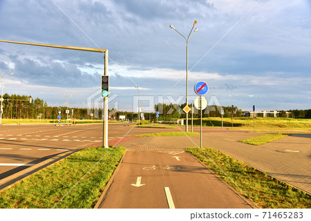 Road sign - the end of cycle path in city at pedestrian zone. Green traffic light signal  71465283