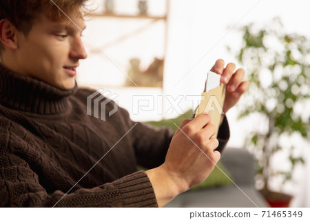 Man opening, recieving greeting card for New Year and Christmas 2021 from friends or family 71465349