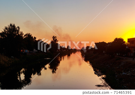 View of irrigation canal at sunset in Egypt 71465391
