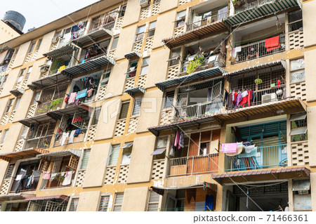 The balconies of an apartment building are hung with clothes. The poor area. Moments of Ordinary Life 71466361