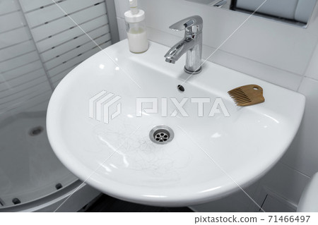 Hair loss. Hair in the sink after combing the head 71466497