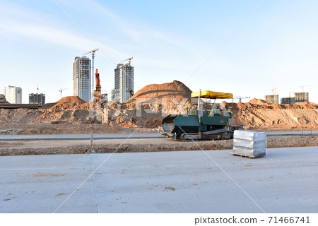 Paving roller machine and excavator during road work. Paving roller machine and excavator during road work. 71466741