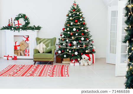 Christmas tree with fireplace interior of white room new year decoration garland gifts Christmas tree with fireplace interior of white room new year decoration garland gifts 71466886