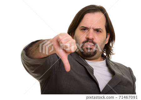 Serious fat Caucasian businessman giving thumb down 71467091