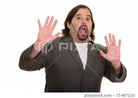 Fat Caucasian businessman looking guilty with arms raised Fat Caucasian businessman looking guilty with arms raised 71467110