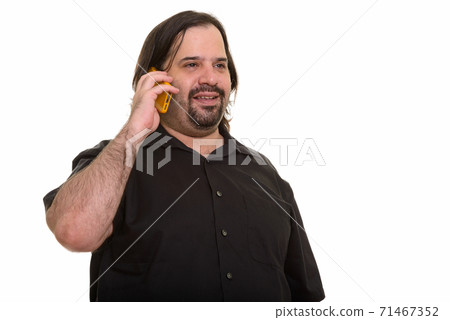 Happy fat Caucasian man smiling and talking on mobile phone Happy fat Caucasian man smiling and talking on mobile phone 71467352