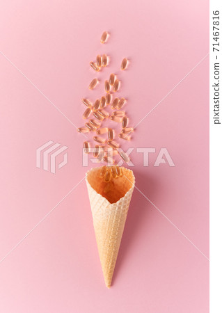 Pile of capsules Omega 3 on pink background. Close up, top view, high resolution product. Pile of capsules Omega 3 on pink background. Close up, top view, high resolution product. 71467816