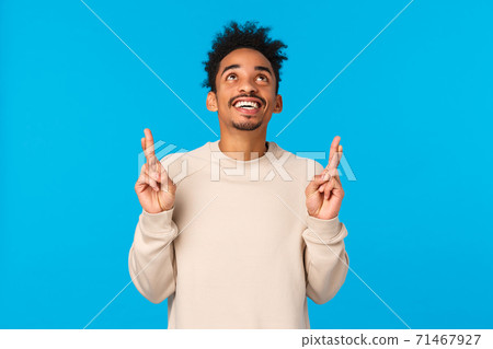 Dreamy excited and happy young man contemplate wonderful fireworks on new year holiday, watching entertaining scene. Attractive african american guy looking and pointing up, smiling happily 71467927