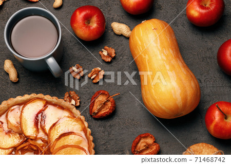 Thanksgiving pie and pumpkin on black background Thanksgiving pie and pumpkin on black background 71468742