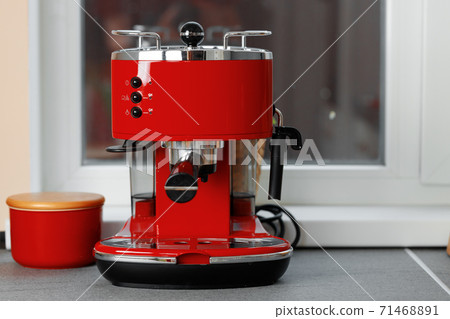 Red domestic coffee machine on kitchen counter Red domestic coffee machine on kitchen counter 71468891