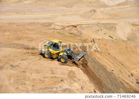 Front end loader has been recovering the landscape around the open pit.  71469246
