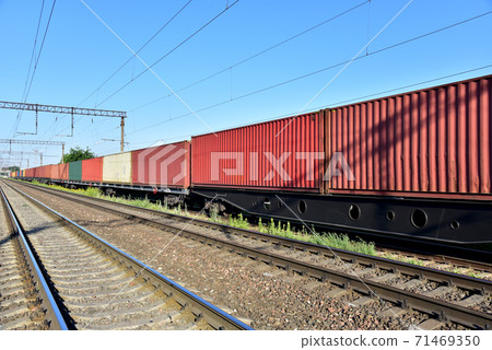 Cargo containers transportation on freight train by railway.  71469350