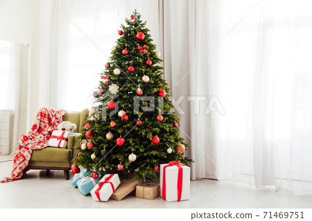 Christmas tree pine with gifts new year decor garland interior of the holiday house December 71469751