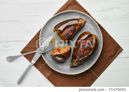 Overhead view of aubergine filled with meat baked in oven Overhead view of aubergine filled with meat baked in oven 71470091
