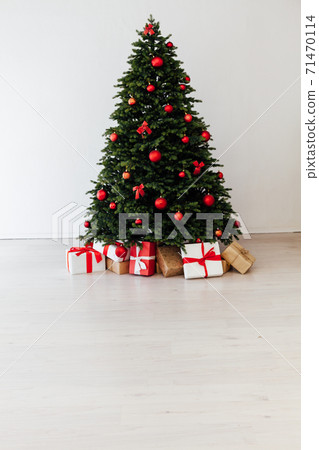 Christmas tree pine with red decor with gifts interior postcard for the new year Christmas tree pine with red decor with gifts interior postcard for the new year 71470114