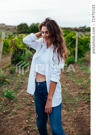 Beautiful woman walks on a picnic in the vineyard 71470185