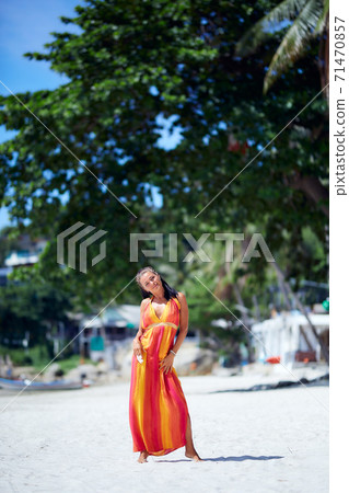 Sexy girl in colorful dress posing at the tropical beach Sexy girl in colorful dress posing at the tropical beach 71470857