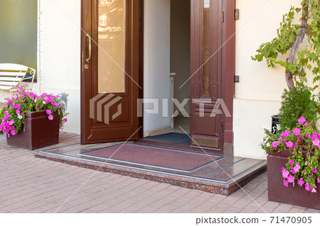 threshold with mat on entrance door in hotel on facade of building close up architecture details, european cityscape nobody. threshold with mat on entrance door in hotel on facade of building close up architecture details, european cityscape nobody. 71470905