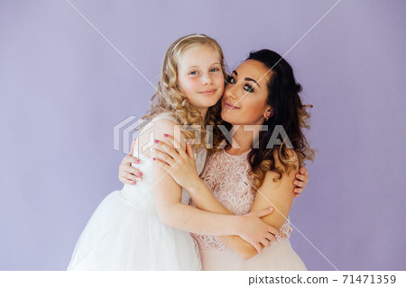Mom brunette and daughter blonde family portrait of love 71471359