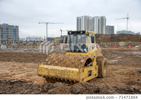 Soil Compactor at construction site. Vibration single-cylinder road roller for leveling soil,  71471804