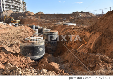 Laying concrete manholes and heating drain pipes and for stormwater system at construction site. 71471805
