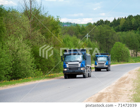 Tipper Dump Truck transported sand from the quarry on driving along highway.  71472039