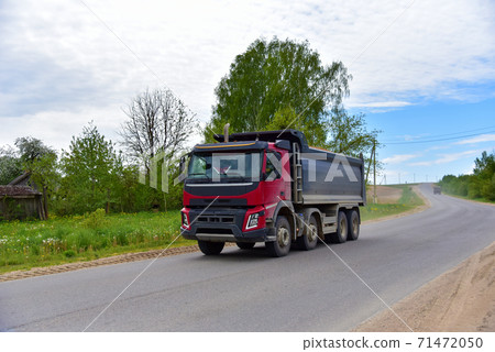 Tipper Dump Truck transported sand from the quarry on driving along highway.  71472050