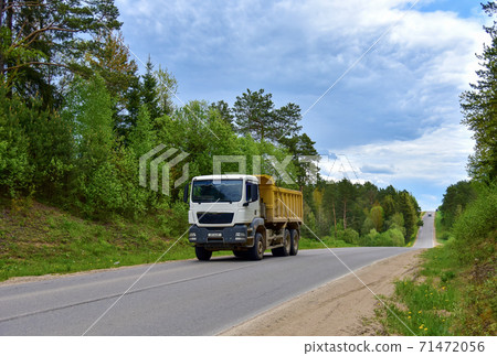 Tipper Dump Truck transported sand from the quarry on driving along highway. Heavy Duty Dump Truck 71472056