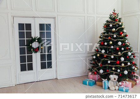 Classic New Year Tree decorated in grunge room interior Classic New Year Tree decorated in grunge room interior 71473617