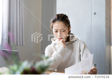 Young woman working at home 71474216