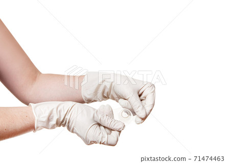 hands on gloves holds contact nipple shield nippleshield for breastfeeding with latch difficulties or flat or inverted nipples, silicone nipple protectors isolated on white background with copy space. hands on gloves holds contact nipple shield nippleshield for breastfeeding with latch difficulties or flat or inverted nipples, silicone nipple protectors isolated on white background with copy space. 71474463