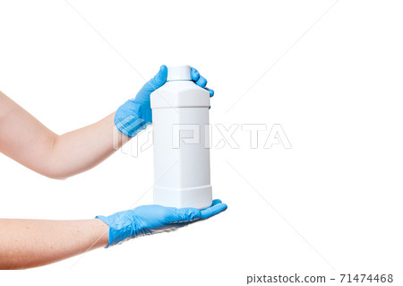hands in blue medical gloves are holding a unlabel plastic white bottle with a cap for a sterile sanitizer isolated on a white background with a copy space. hands in blue medical gloves are holding a unlabel plastic white bottle with a cap for a sterile sanitizer isolated on a white background with a copy space. 71474468