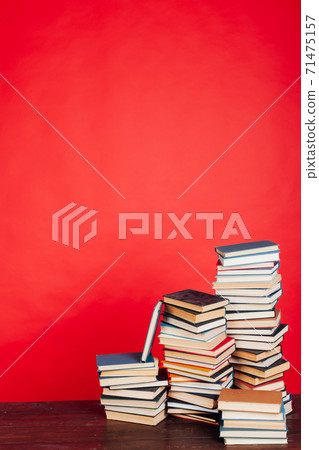 many stacks of educational books to study in the university library as a background 71475157