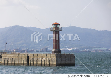 Red lighthouse on the Tamamo breakwater at Takamatsu Port 71475307