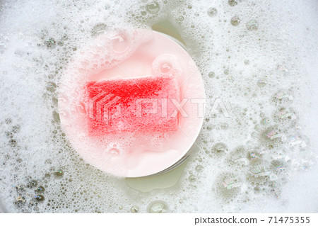 Washing dishes, Close up of utensils soaking in kitchen sink. 71475355