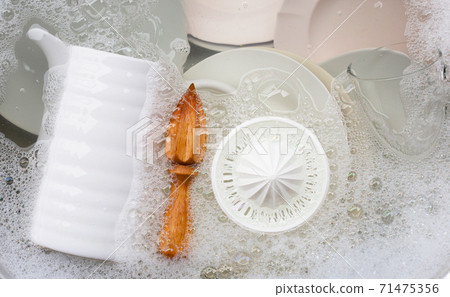 Washing dishes, Close up of utensils soaking in kitchen sink. Washing dishes, Close up of utensils soaking in kitchen sink. 71475356