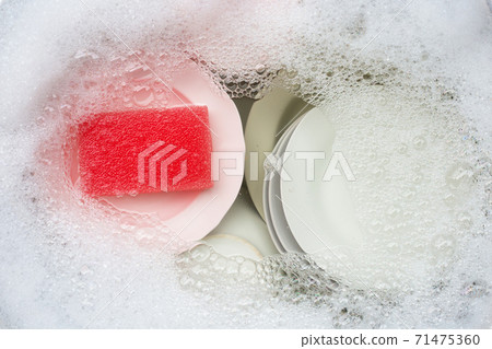 Washing dishes, Close up of utensils soaking in kitchen sink. 71475360