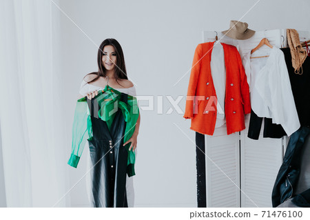 Beautiful young woman trying on shoes in her dressing room 71476100