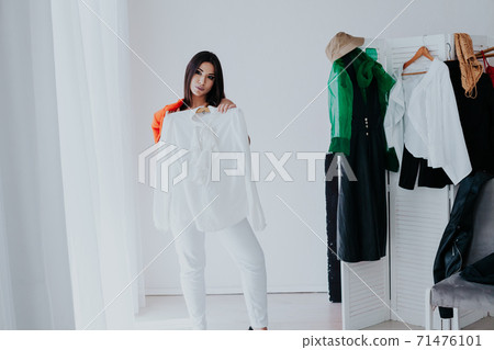 Beautiful young woman trying on shoes in her dressing room 71476101